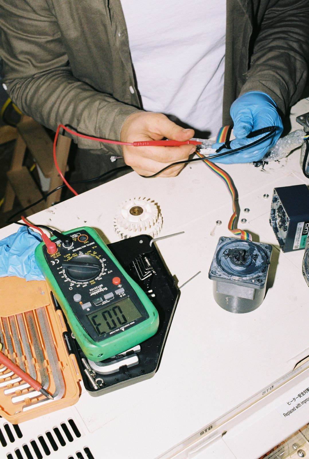 Testing a processor's electronics by hand with a multimeter during a conversion